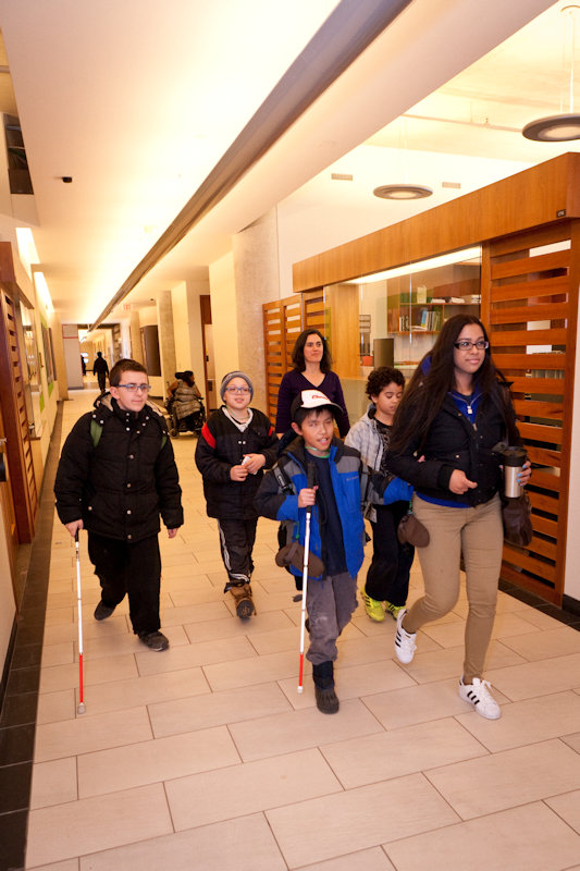 CNIB camp kids with canes leaving the office walking down the corridor.